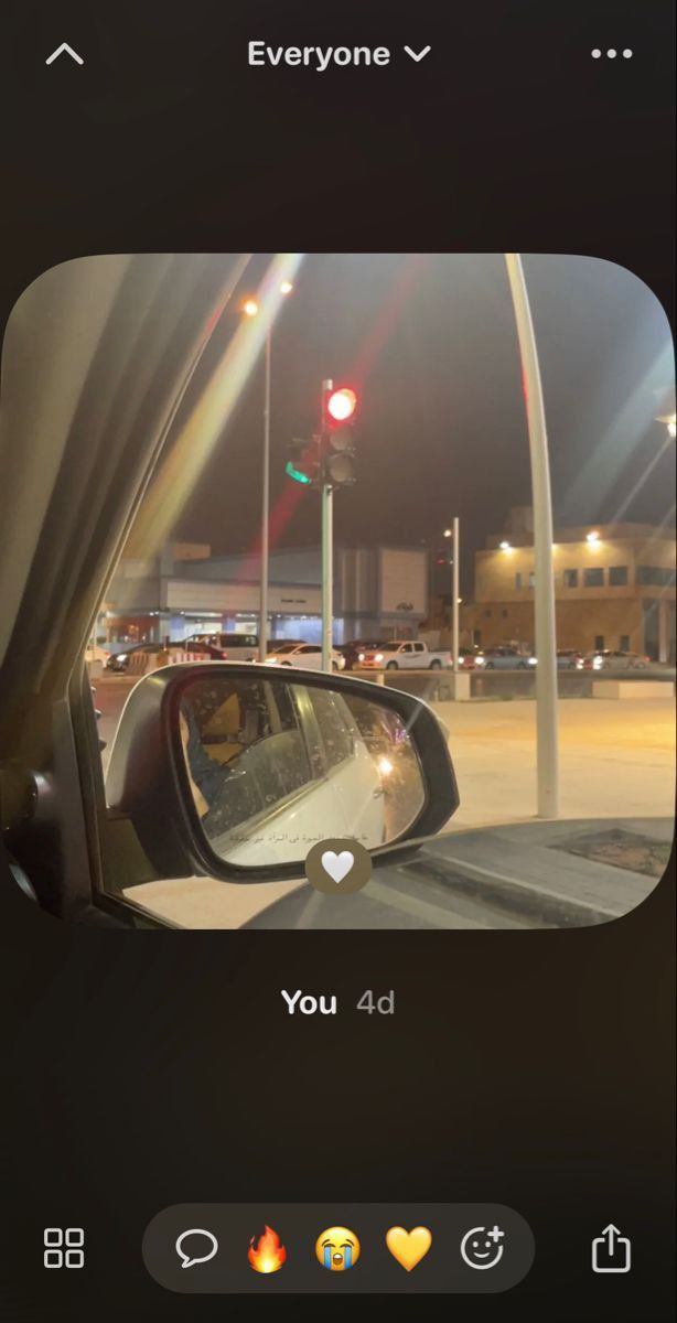 the rear view mirror of a car at night