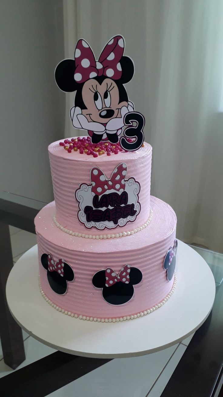 a three tiered cake with minnie mouse on it's top and the number six