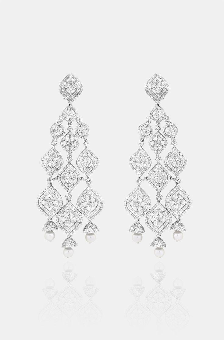 Introducing exquisite long Diamond dangler earrings, adorned with shimmering faux diamonds and graceful pearl drops, set against a pristine white finish. This statement piece exudes elegance and adds a touch of ravishing allure to any ensemble. Finish: Rhodium Material: Brass, Faux Diamonds, Pearls Color: White Size: One Size Closure Type: Push Back Box Contains: 1 Pair of Earrings Exquisite White Diamond Earrings For Evening, Luxury White Cubic Zirconia Linear Earrings, Luxury Earrings For Receptions, Luxury Earrings For Reception, Glamorous White Bridal Earrings With Elegant Design, White Pearl Drop Earrings For Reception, Silver Opulent Earrings For Evening, Elegant Pearl Drop Chandelier Earrings For Reception, Opulent Silver Earrings For Evening