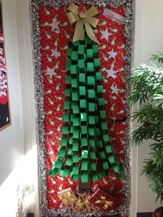 a christmas tree made out of green origami blocks on a red and silver background