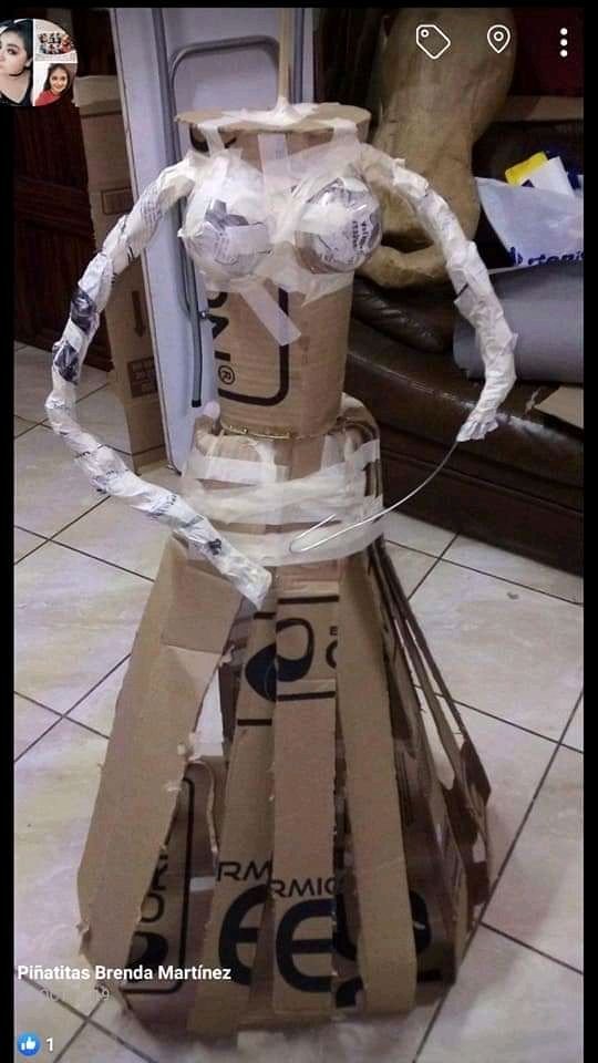 a cardboard dress made to look like it is wrapped in tape and taped around the neck