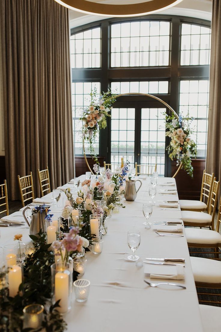 a long table with candles and flowers on it