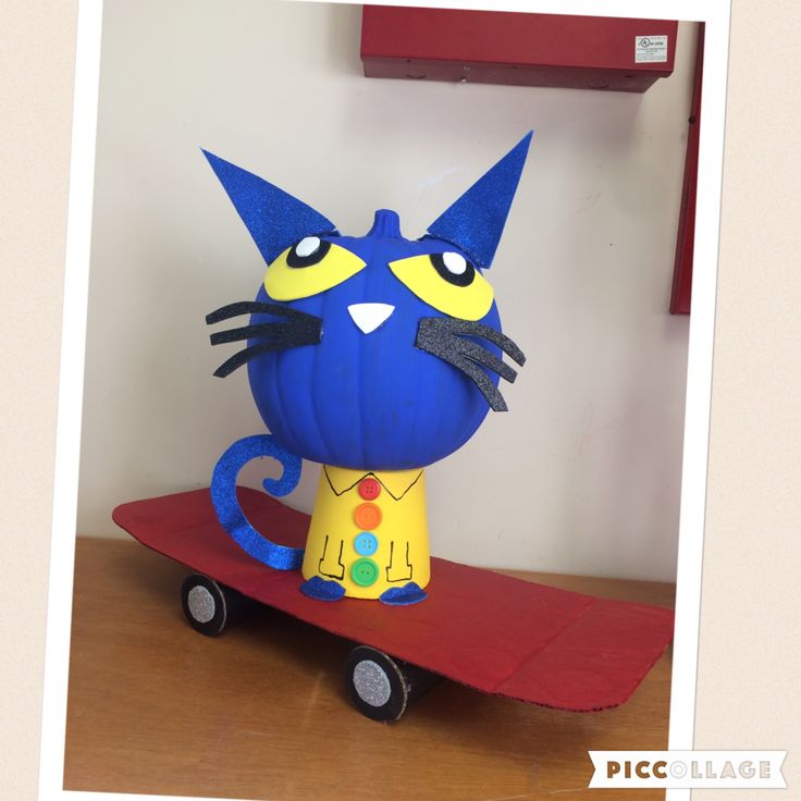 a paper model of a blue cat on a red cart with yellow and orange wheels