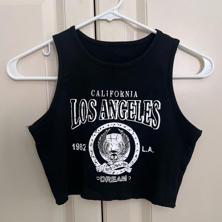 Shein Los Angeles Black Halter Racer Back Crop Top Nwot Size Xs Shein, Crop, Tops, Crop Top, Racerback, Halter, Halter Top, High Neck, Black, Black Crop Top, Tank, Brandy, Brandy Melville, Casual, Summer, Xs, Trendy, Nwot, Hem, La, Los Angeles, California, Ca, Cali Casual Letter Print Tank Crop Top, Y2k Black Tank Top With Letter Print, Black Letter Print Crop Top For Summer, Casual Cropped Letter Print Tank Top, Black Letter Print Tank Top For Spring, Black Crop Top With Letter Print For Spring, Trendy Black Tank Crop Top, Black Letter Print Crop Top For Spring, Casual Black Tank Crop Top