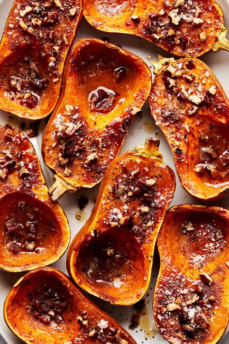 roasted acorns on a white plate topped with nuts