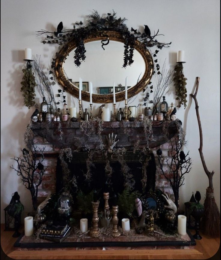 a mantel with candles and branches on it in front of a mirror that is above the fireplace