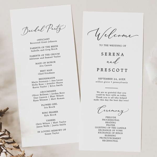 two white wedding programs sitting on top of a table