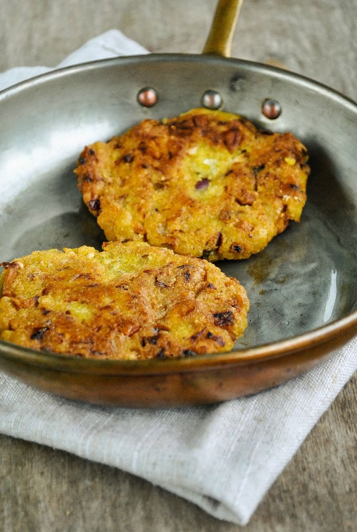 two crab cakes in a frying pan on a table