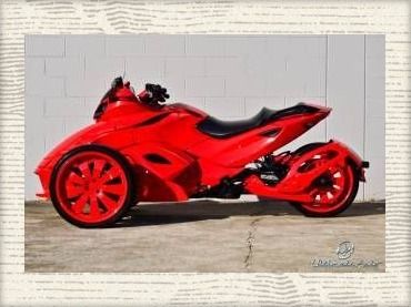 a red motorcycle parked in front of a building