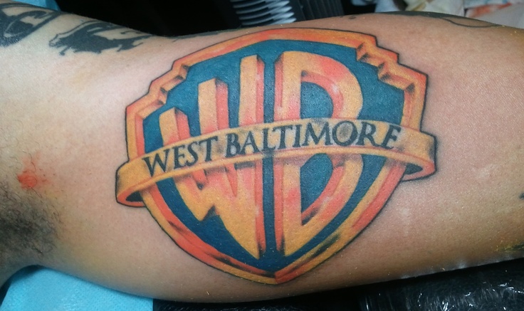 a man with a tattoo on his arm that says west baltimore in an old school style shield