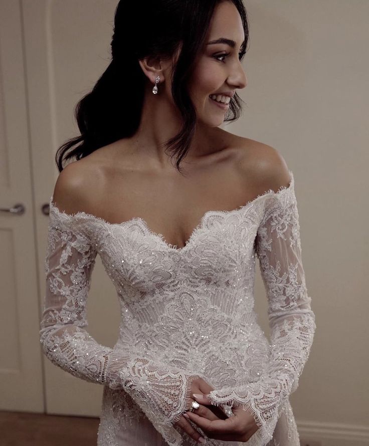 a woman in a wedding dress is smiling