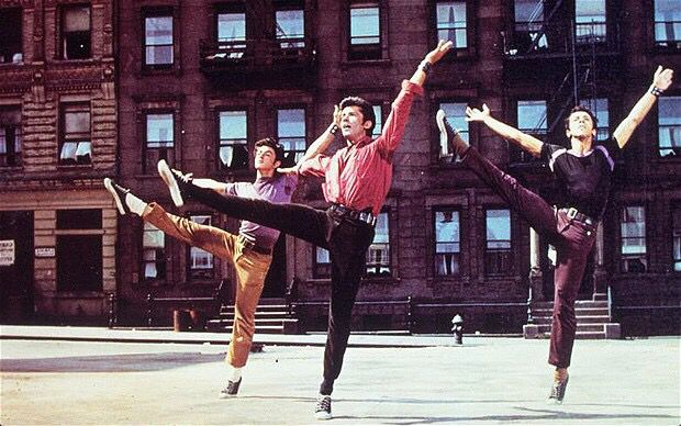 three people doing tricks in front of a building