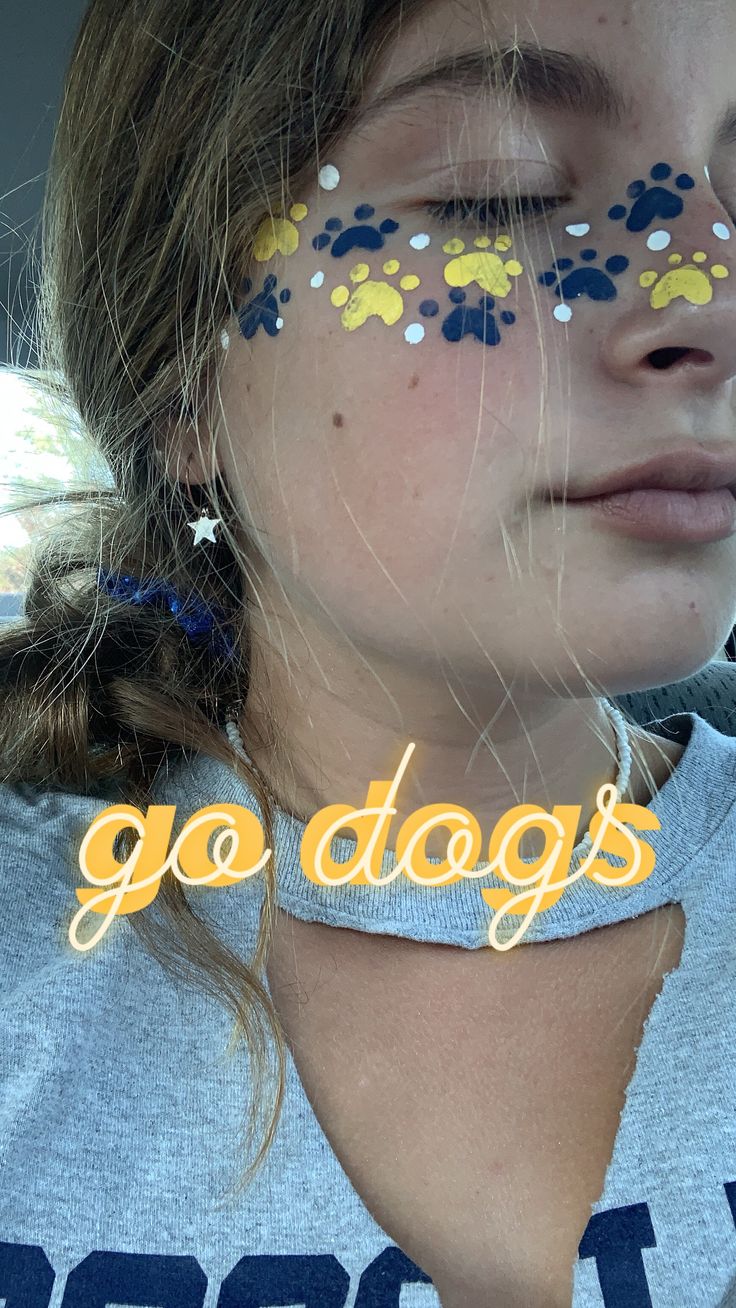 College Face Paint, High School Football Makeup, Paw Face Paint, Paw Print Makeup, Hoco Face Paints, Face Paint Designs For Football Games, Glitter On Face Football Game, Face Painting Sports, Prep Rally Face Paint