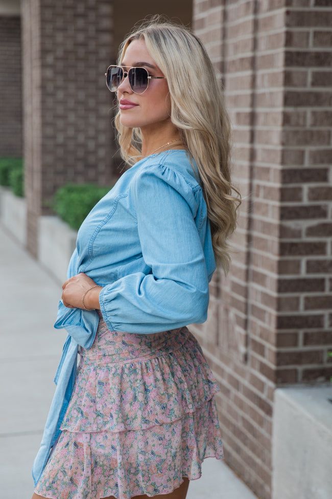 Details Light Wash Chambray Wrap Blouse Fabric has no stretch besides in smocking bishop sleeves, wrap style, smocked waist on back, v-neck style Pair this blouse with a skort! Unlined Size small from shoulder to hem: 17" Material and Care 100% cotton Hand wash cold, no drum drying Patterns may vary Materials may have natural variations Colors may vary from different viewing devices Spring V-neck Smocked Top With Gathered Sleeves, Spring Blouse With Tie Waist For Day Out, Spring Day Out Fitted Wrap Top, Chic V-neck Smocked Top With Blouson Sleeves, Fitted Wrap Top For Day Out In Spring, Casual Blouse With Tie Waist For Brunch, Casual Wrap Top For Day Out, V-neck Smocked Top With Smocked Cuffs For Brunch, Casual V-neck Blouse With Elastic Waistband