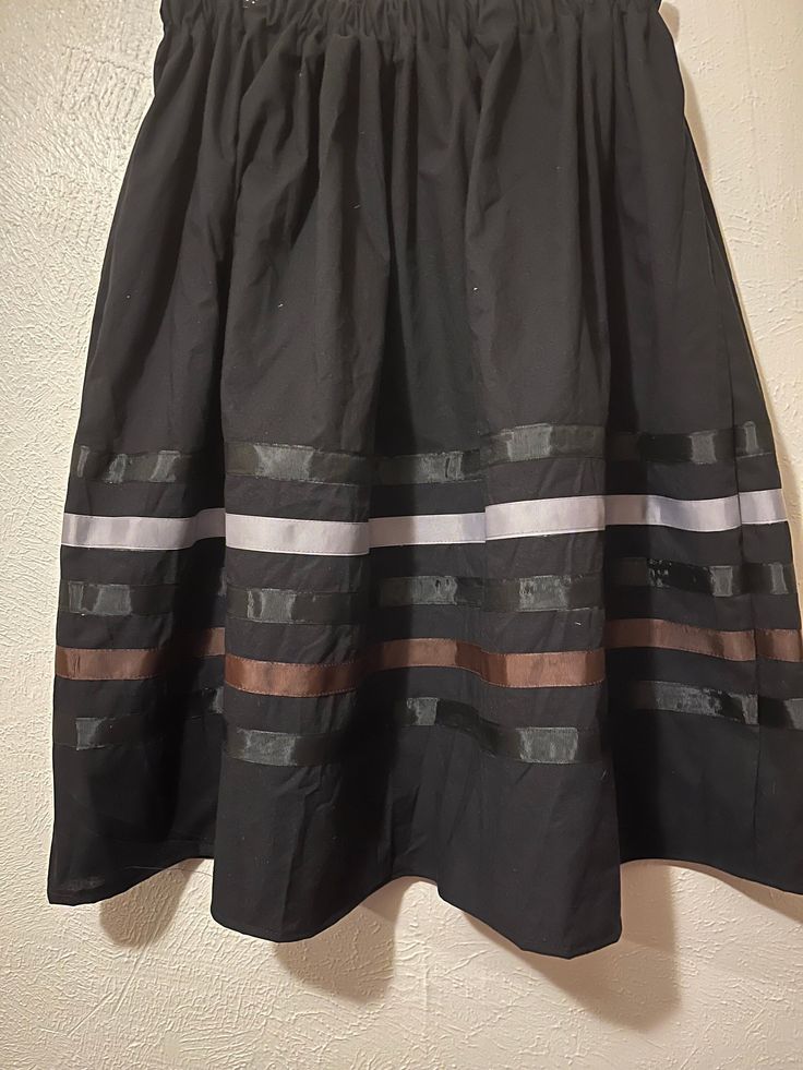 Native American Ribbon skirt- black, gray and brown ribbons. Ribbon Skirt - PLEASE CHOOSE YOUR SIZE BELOW! Skirt has an elastic waist that gives it the elusion of an A-line skirt.  Most skirts are 100% cotton or primarily cotton. Authentic Native American design for Pow Wow and Native American dances. They are approximately 32 inches long and most are about 32 inches in the waist.   RUSH SHIPPING: If you need to rush your shipping, (anything out of the normal) please note that I use USPS Priority Mail. You can change the shipping if you need to but please note, you will be charge for it and  I will also ask you to pay a RUSH fee. It is not fair to my other customers to have to move you to the front. There will be a fee of about $20 ($18 because shipping had to be added but I put in minimal Black Relaxed Midi Skirt, Relaxed Black Midi Skirt, Black Lined Flared Skirt, Black Relaxed Lined Skirt, Black Relaxed Fit Lined Skirt, Black Voluminous Skirt With Elastic Waistband, Black Tiered Skirt With Elastic Waistband, Long Black Skirt With Elastic Waistband, Black Full Skirt With Lining