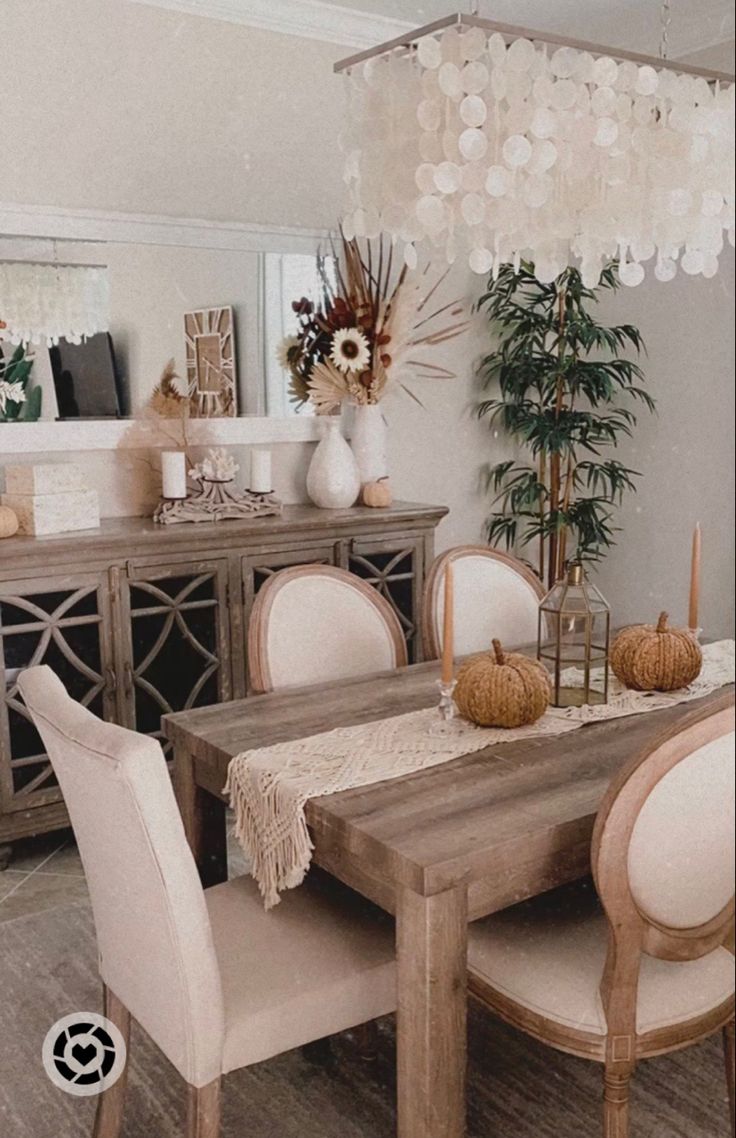 the dining room table is set with white chairs