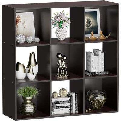 a book shelf filled with books and vases