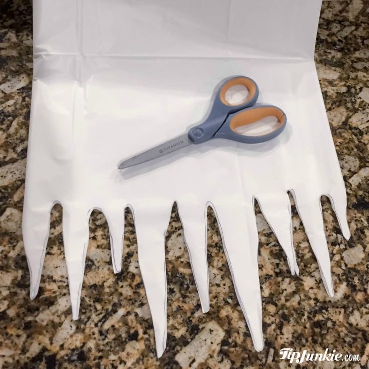 a pair of scissors sitting on top of a white bag