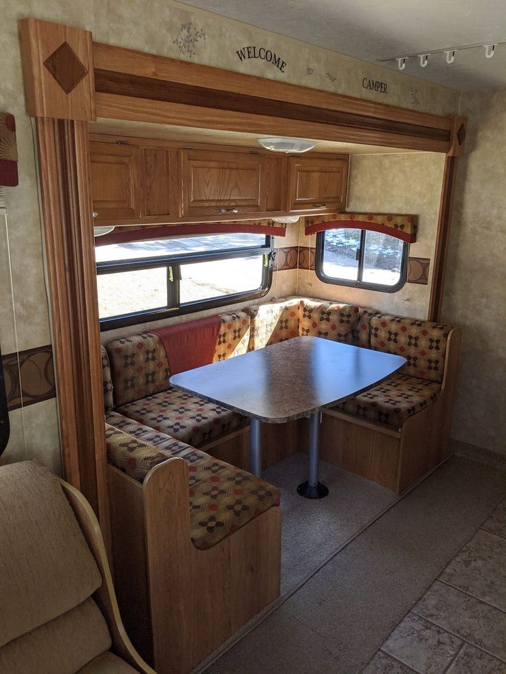 the inside of an rv with couches and tables