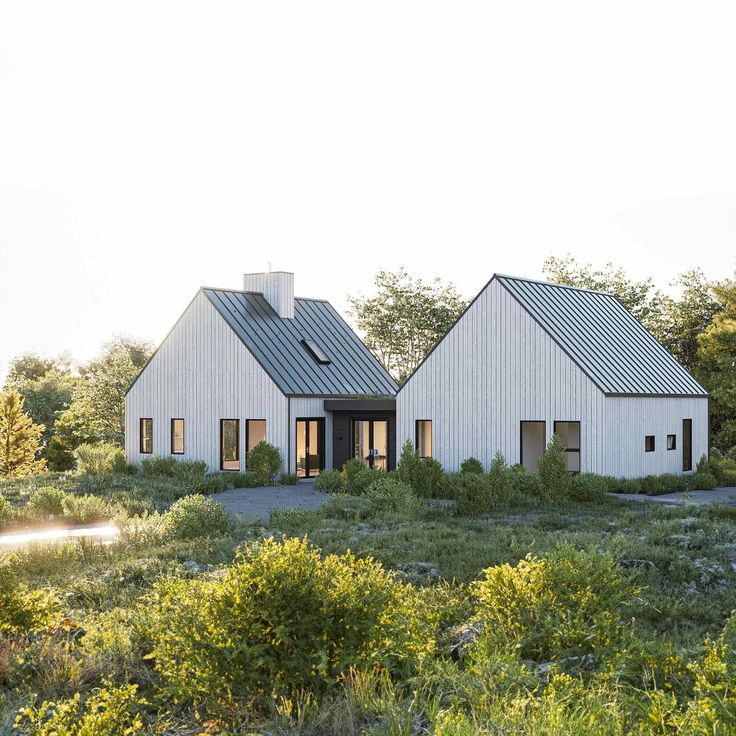 two white houses in the middle of a field