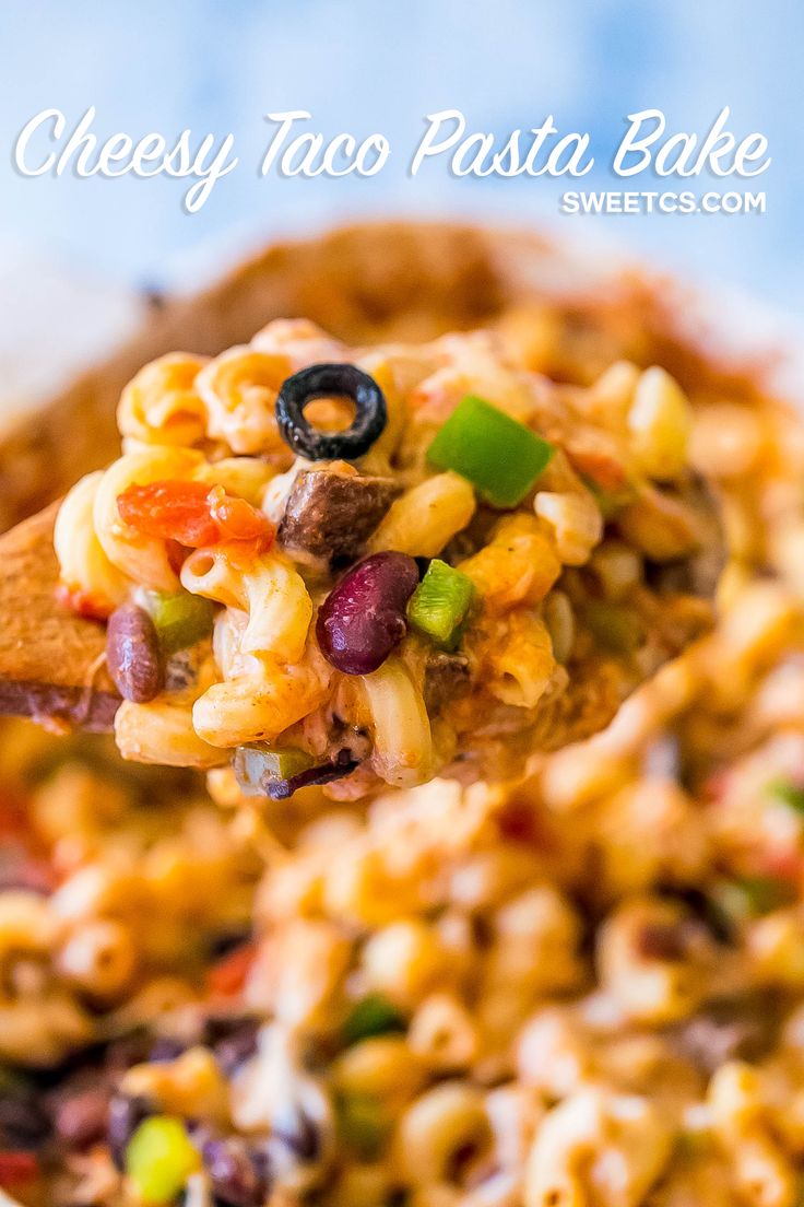 a spoon full of cheesy taco pasta bake with black olives