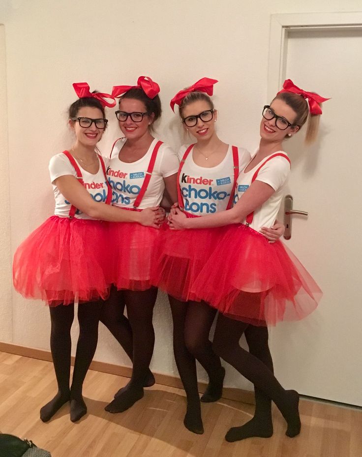 three girls in red tutu skirts are posing for the camera with their arms around each other