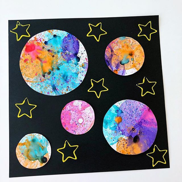 an art project made out of paper with stars and moon shapes on the bottom half