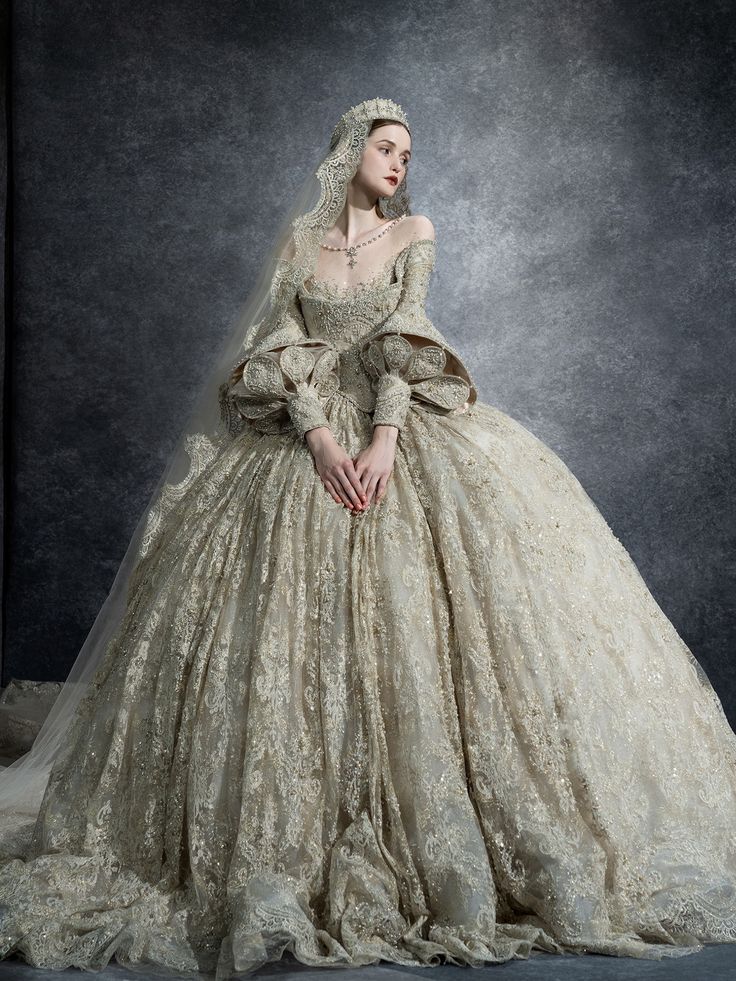 a woman in a wedding dress is posing for a photo with her hands on her hips