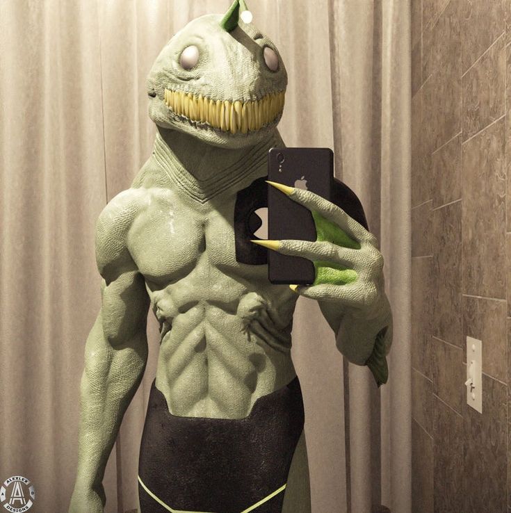 a man dressed as an alien taking a selfie with his cell phone