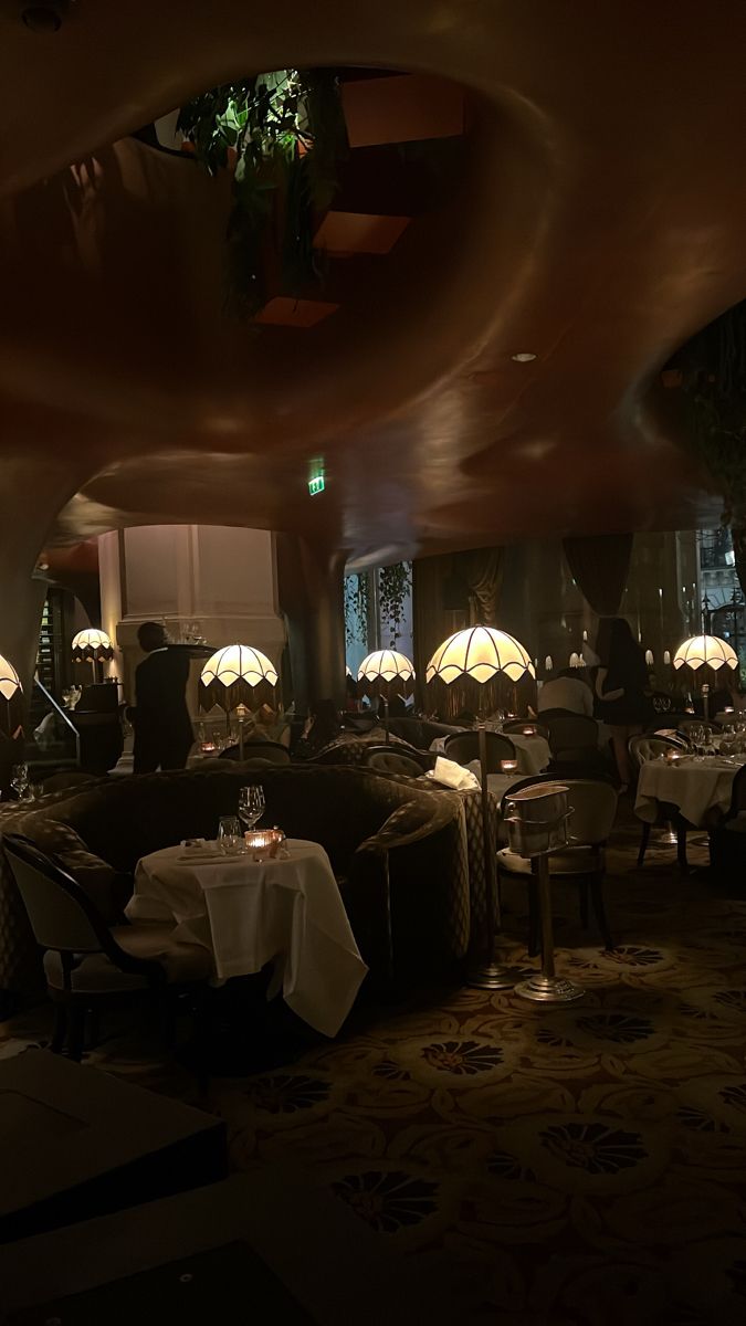 a dimly lit restaurant with tables and chairs