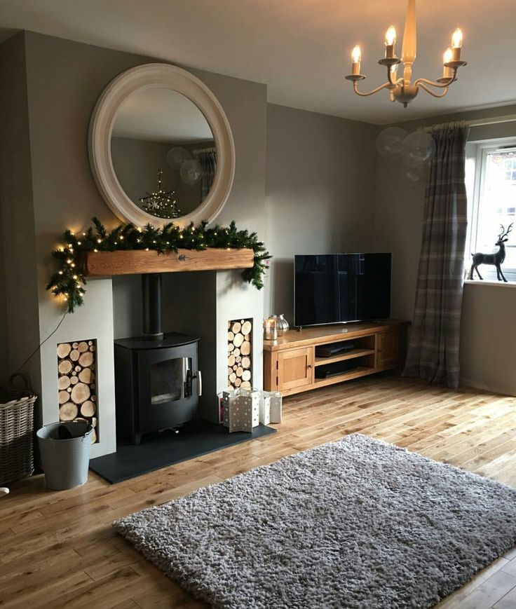 a living room filled with furniture and a fire place next to a tv on top of a hard wood floor