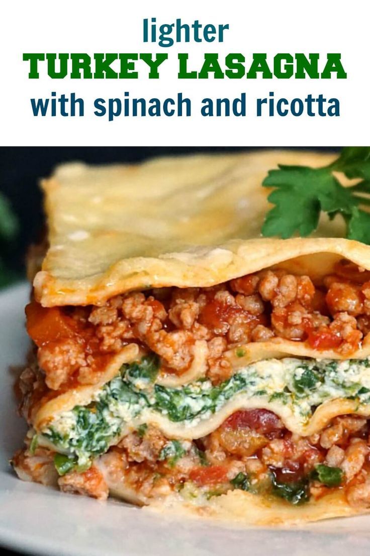 a close up of a plate of food with lasagna in the background and text overlay that reads lighter turkey lasagna with spinach and ricotta