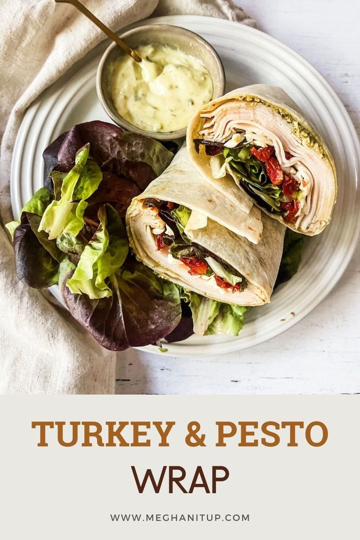 turkey and pesto wrap on a plate with lettuce