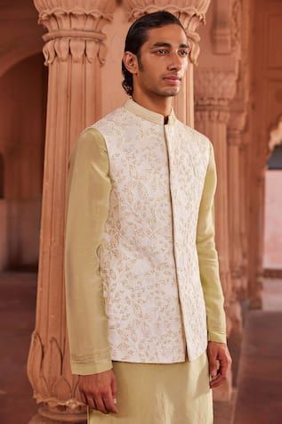 Ivory bundi with bead embellishment in floral pattern. Paired with gold kurta and pant. - Aza Fashions Silk Nehru Jacket For Eid Reception, Silk Nehru Jacket For Reception During Eid, Silk Nehru Jacket With Zari Work For Reception, Festive Silk Nehru Jacket For Reception, Traditional Silk Nehru Jacket For Reception, White Bandhgala With Floral Embroidery For Festive Occasions, Nehru Jacket With Floral Embroidery For Reception And Festivals, Floral Embroidered Nehru Jacket For Reception And Festivals, White Floral Embroidered Bandhgala For Festive Occasions