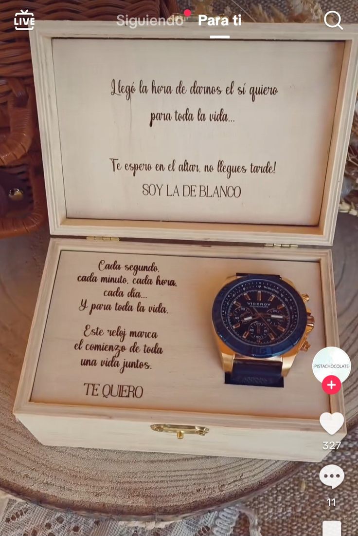 a wooden box with a watch in it