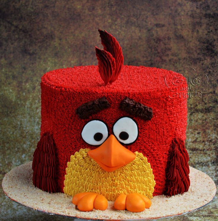 a red cake with an angry bird on top