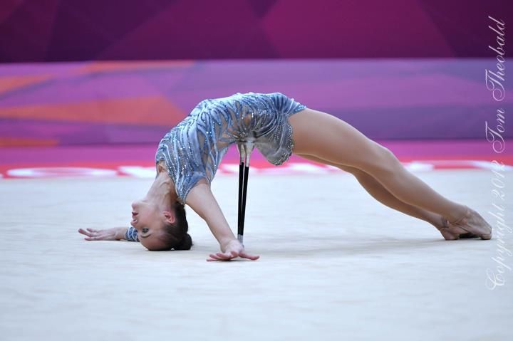 a woman is doing a handstand on the floor