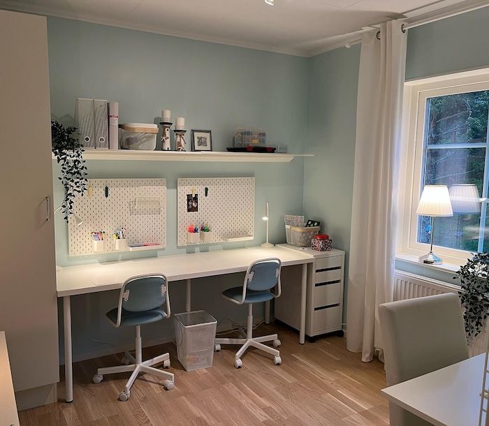 a home office with two desks and chairs