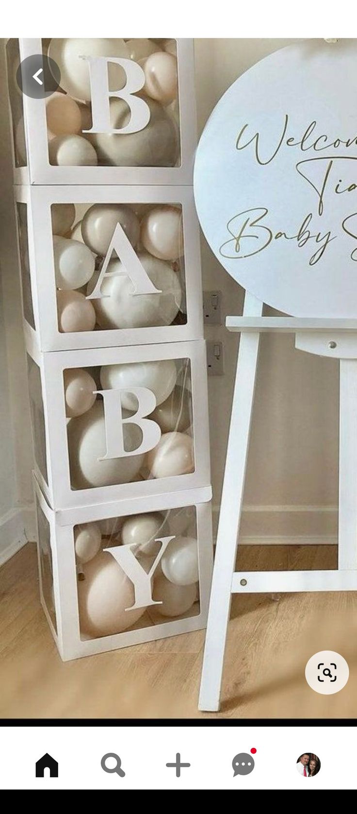 a welcome baby sign with balloons in the shape of letters and numbers is displayed next to an easel