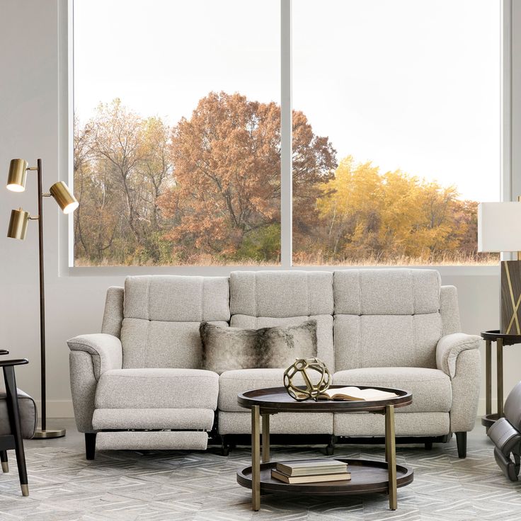 a living room filled with furniture and a large window