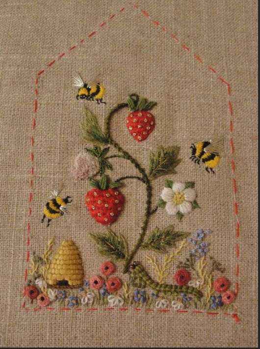 a close up of a piece of cloth with flowers and bees on it in the shape of a beehive