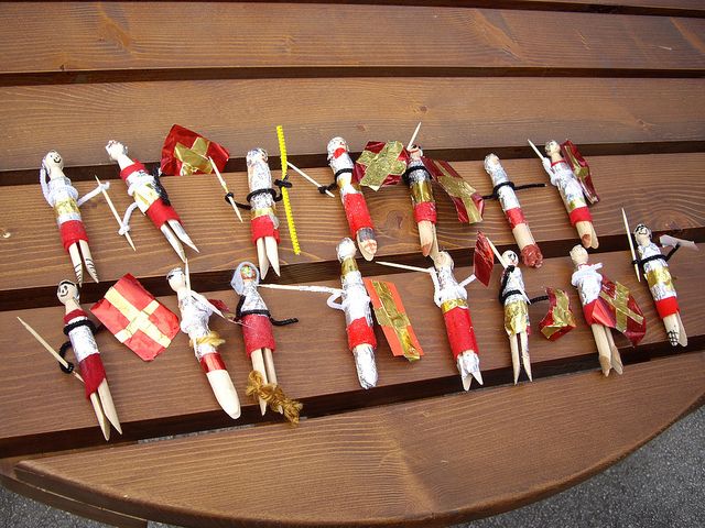 wooden toy soldiers lined up on a bench