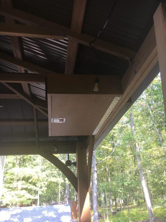 the back porch is covered with wood and metal