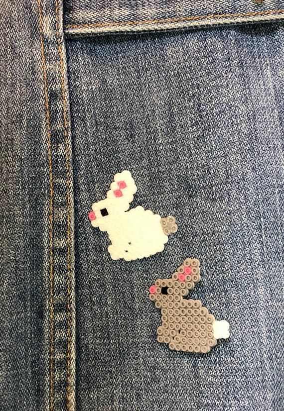 a pair of patches on the back of a jean jacket with an image of a dog and a cat