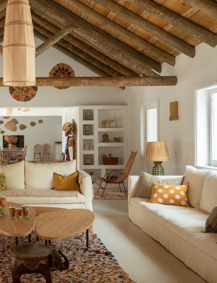 a living room filled with furniture and lots of windows