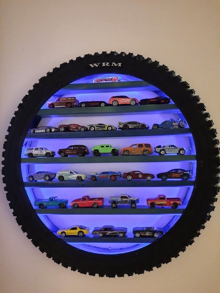 a wall mounted display case filled with lots of toy cars