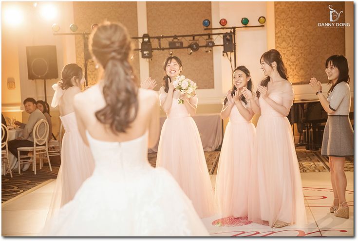 a group of young women standing next to each other in front of a microphone on top of a dance floor