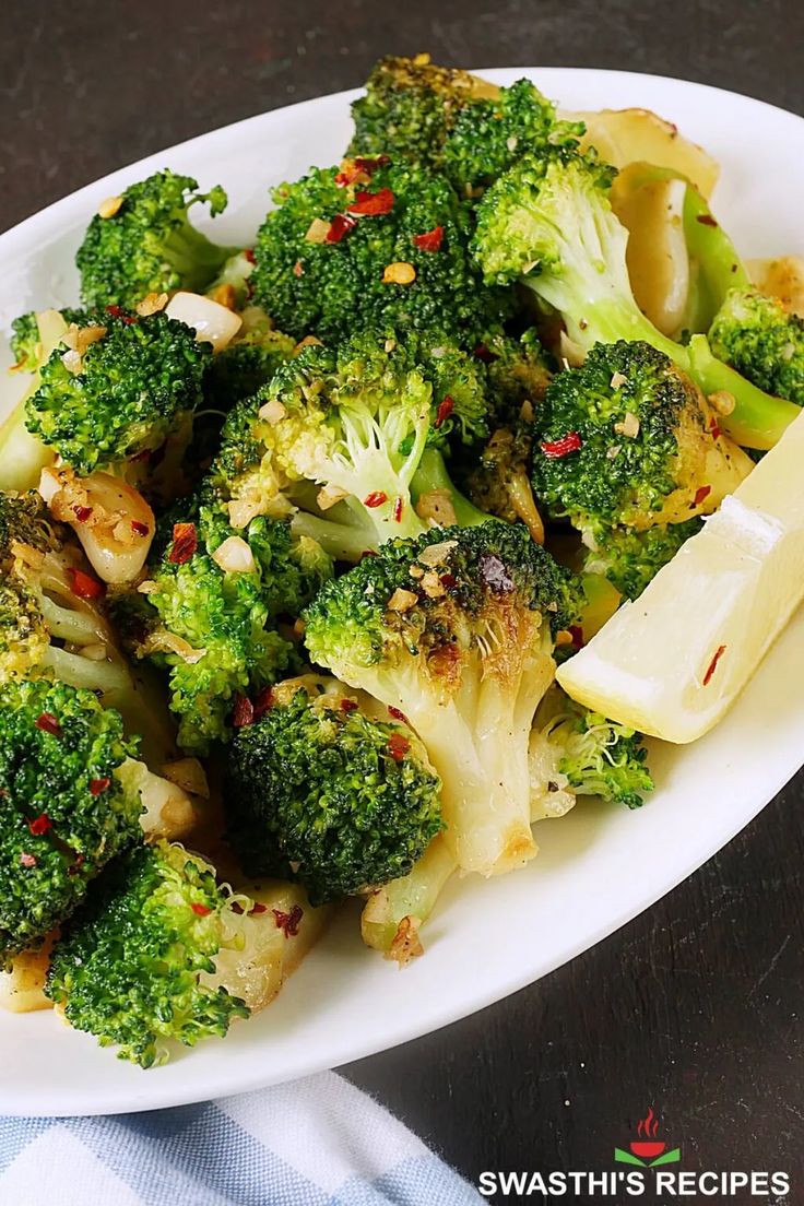 a white plate topped with broccoli covered in seasoning