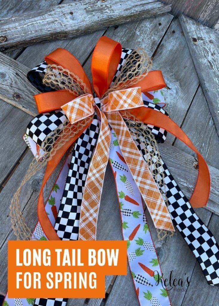 the long tail bow for spring is decorated with carrots and checkered ribbon on an old door