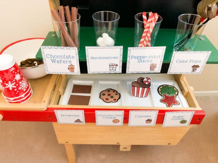 an assortment of chocolate and marshmallows displayed on a table with cup holders